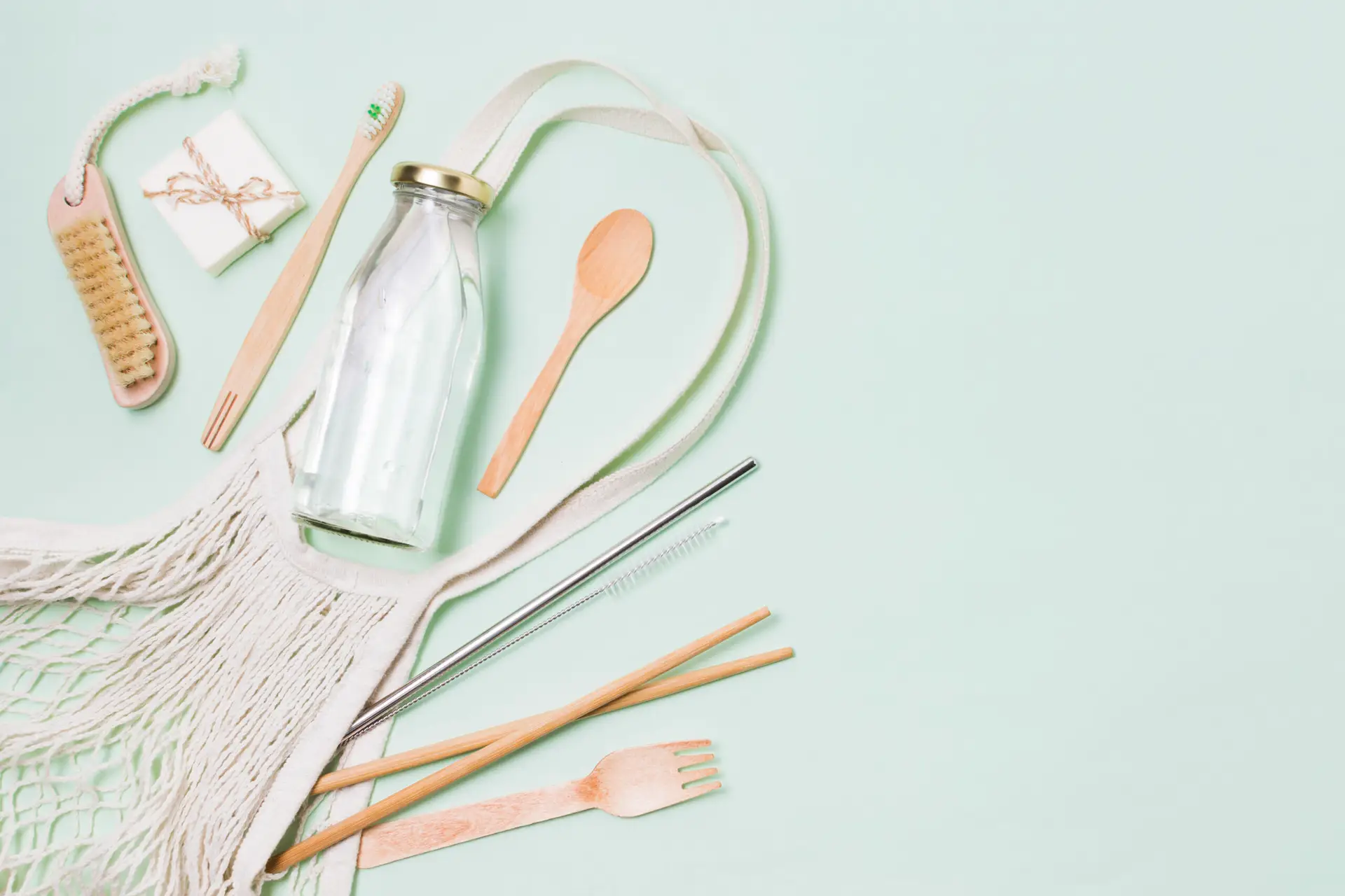 composition-zero-waste-products-green-background-with-copy-space-scaled